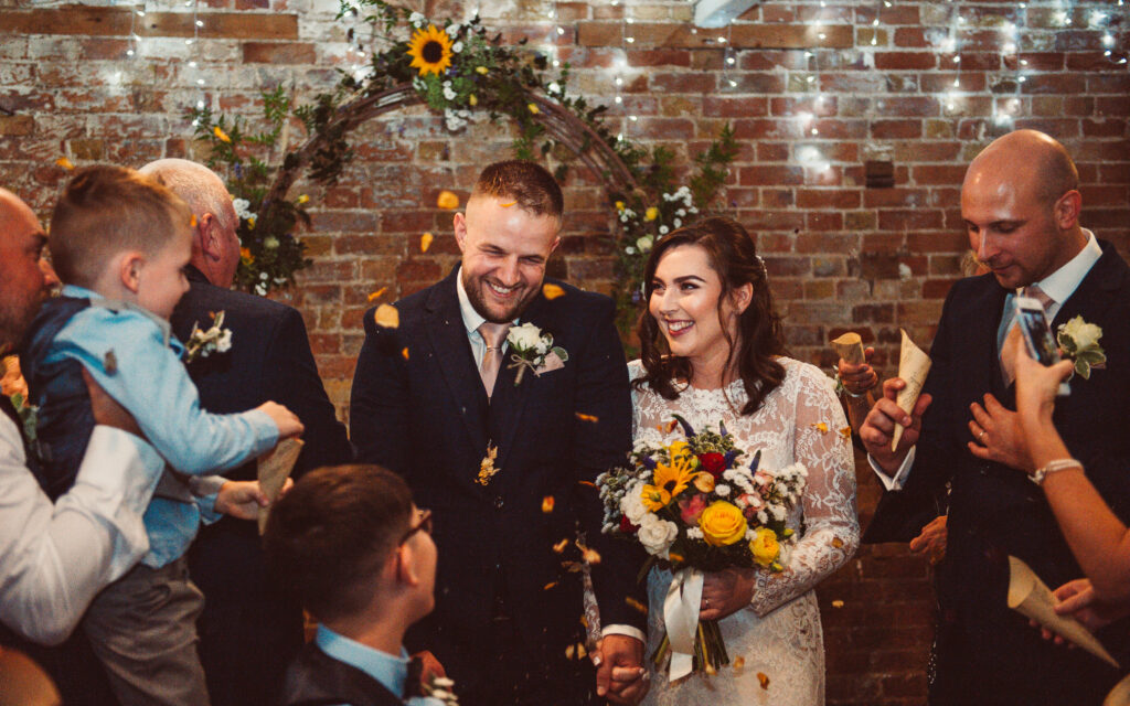 Indoor confetti throwing shot by Kent Wedding Photographer Tom Keenan