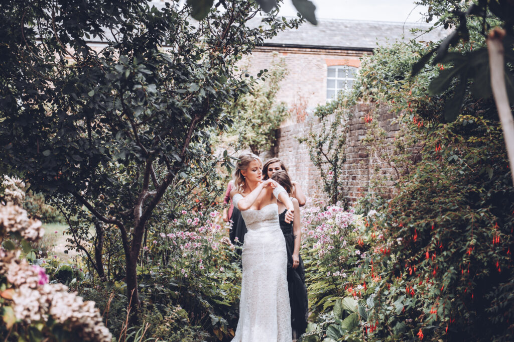 Bride fixing her dress at her luxury wedding in Deal Kent