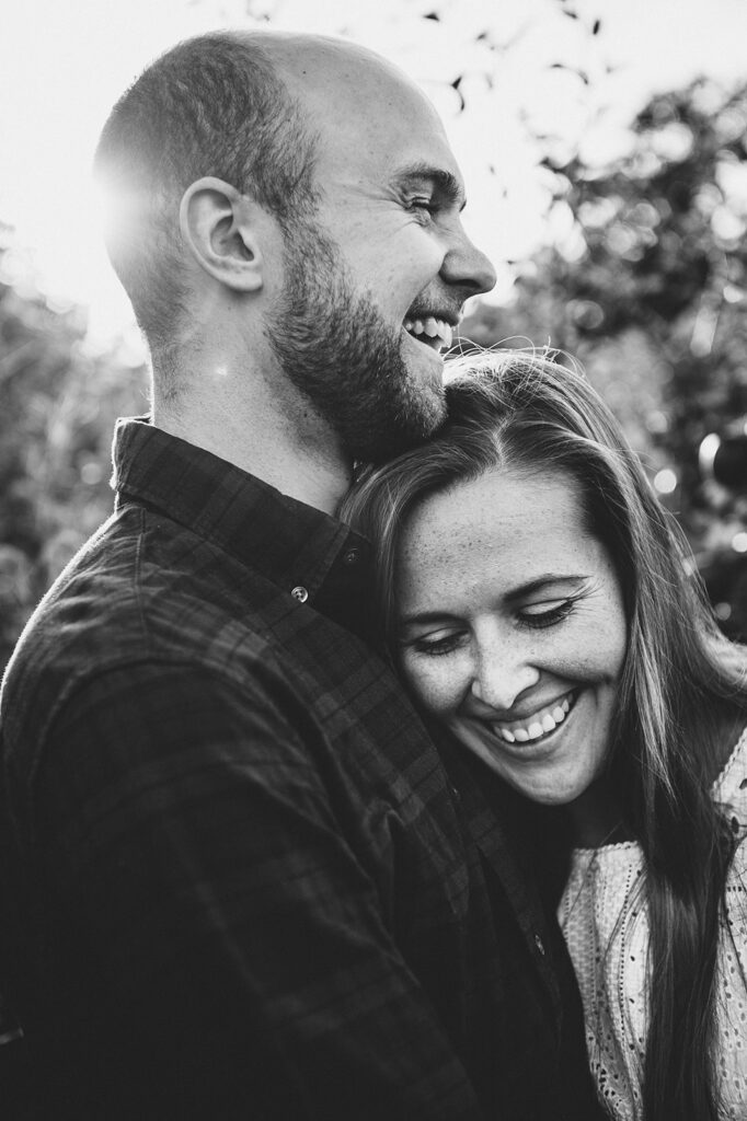 Photograph of a couple in Kent who just got engaged having a cuddle.