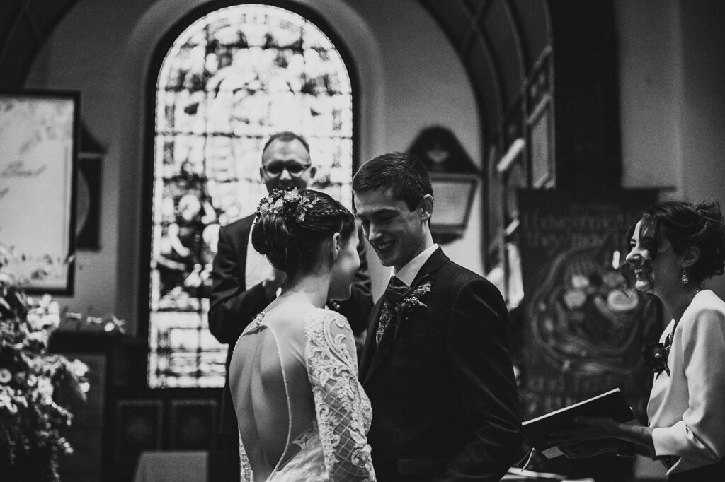 A wedding ceremony taking place inside a Kent church, with the bridal couple and guests