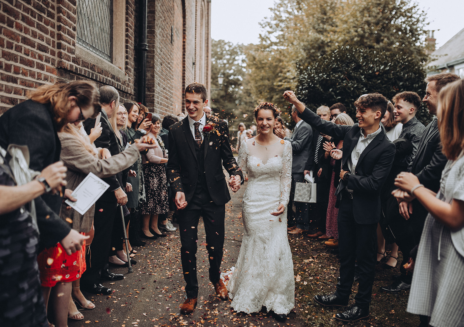 A gen z couple getting showered in confetti at their wedding in Kent