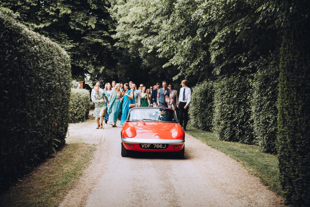 A groom driving a luxury car on his way to get married in Kent.