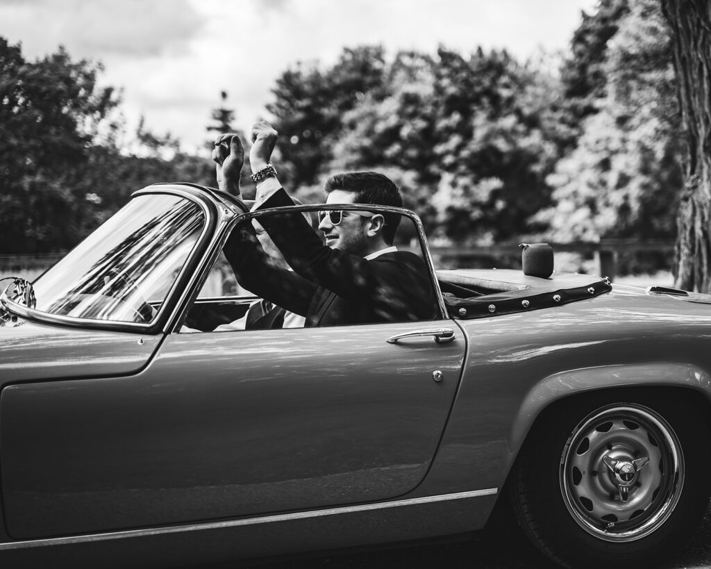 Groom arriving to his wedding in a luxury sports car