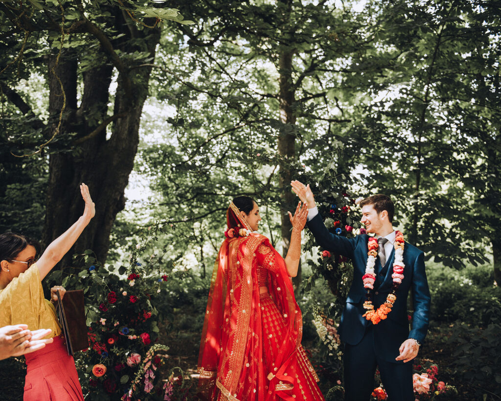 bride and groom high fiving after ceremony