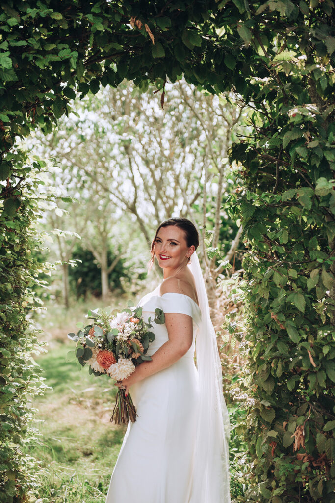 A bride smiling at her husband at her luxury wedding venue, behind the scenes of Editorial Wedding Photography: A Luxury Couple's Shoot