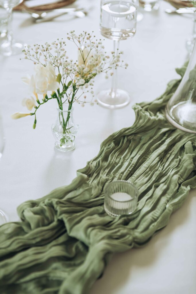 Luxury table landscape with neutral greens, flowers and tableware