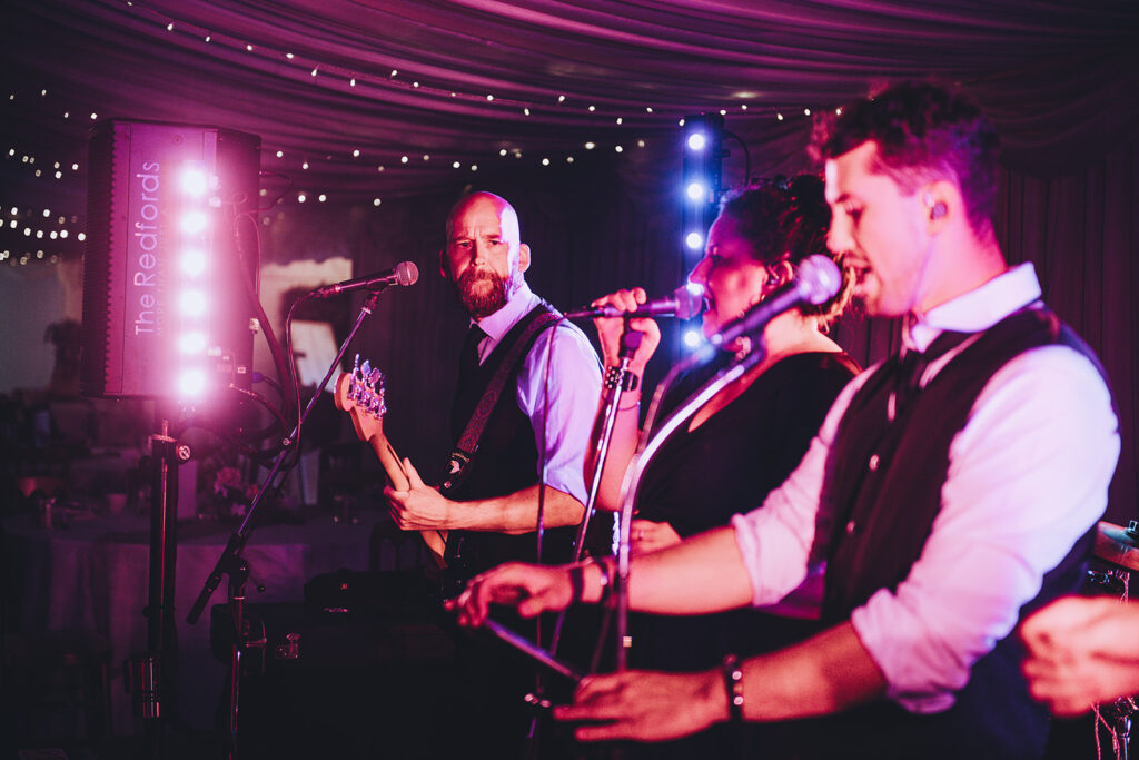 Band reading their music on iPads at a wedding