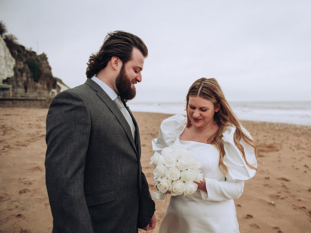Bride and groom smiling at Botany Bay during their wedding