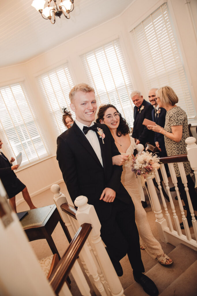 Bride and groom walking out of wedding venue