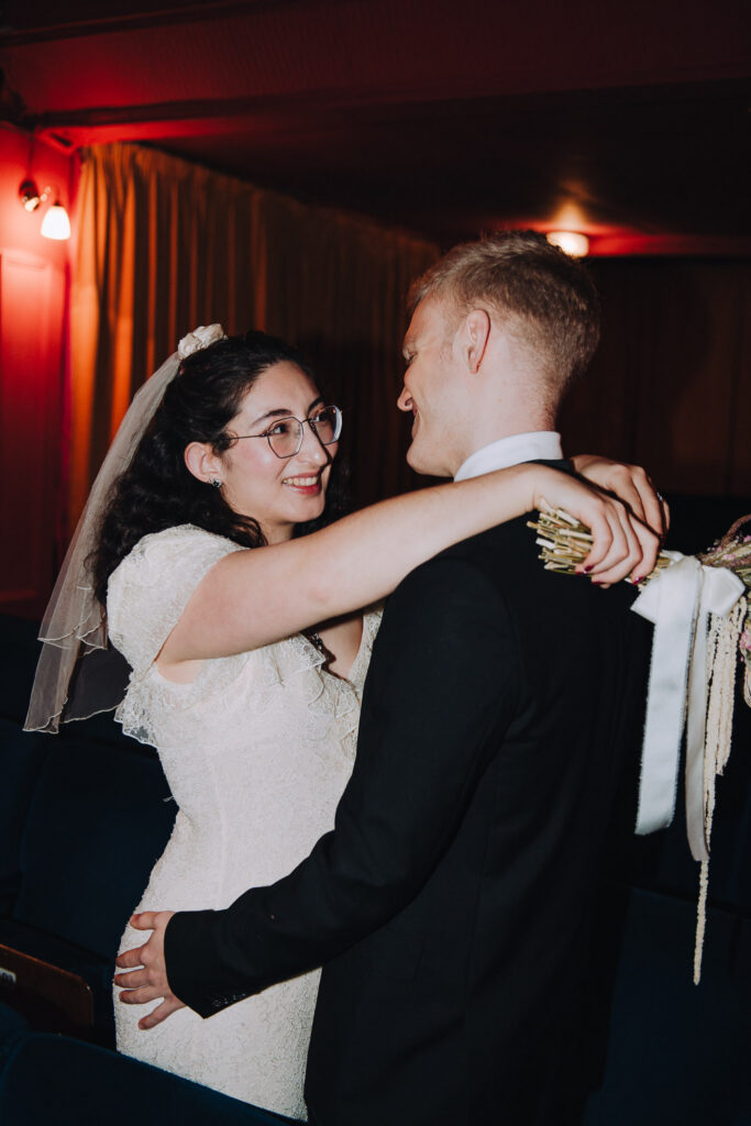 Bride and groom hugging in the Palace Cinema in Broadstairs