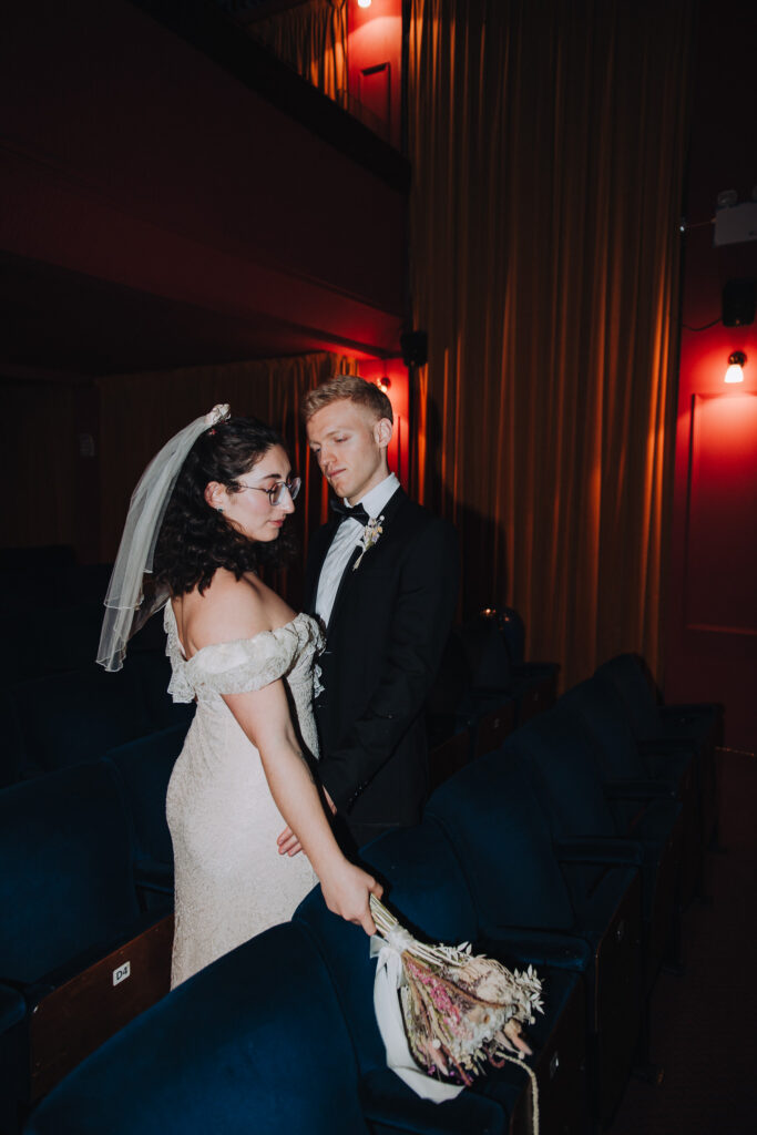 Bride and groom standing together in the Palace Cinema in Broadstairs