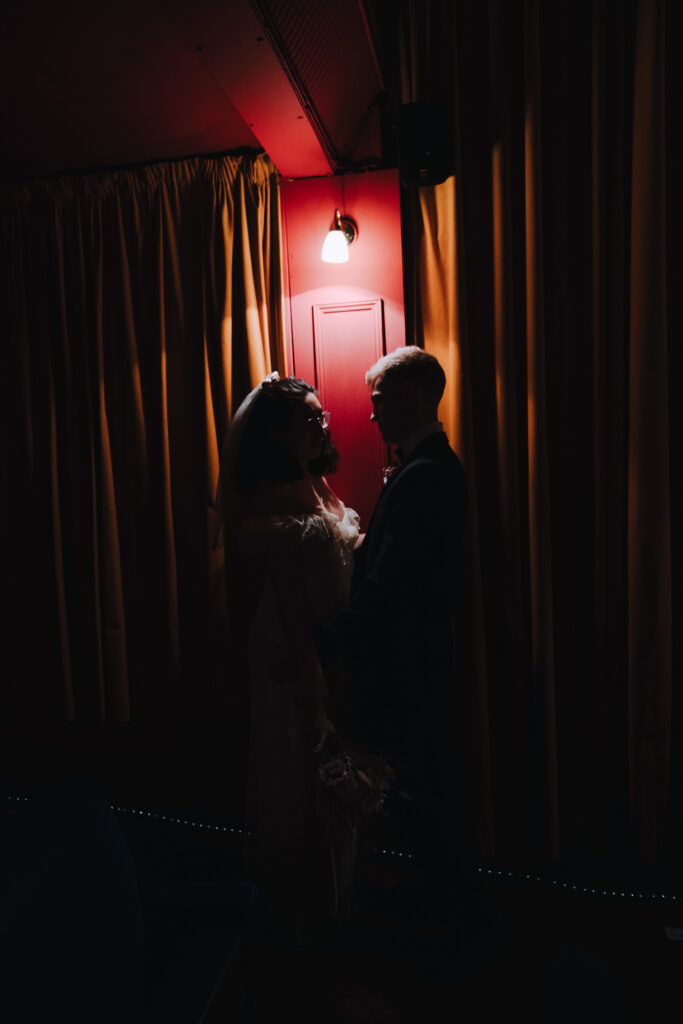 Bride and groom standing together in the Palace Cinema in Broadstairs