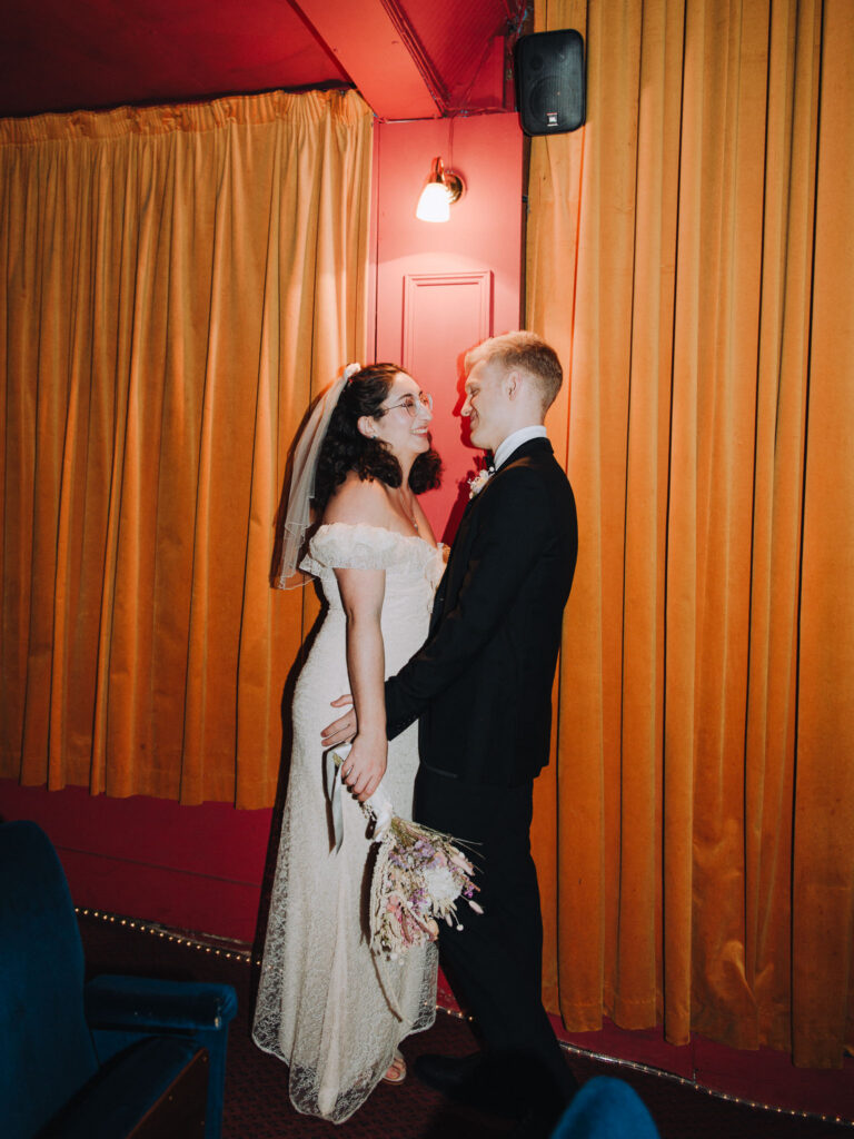 Bride and groom standing together in the Palace Cinema in Broadstairs