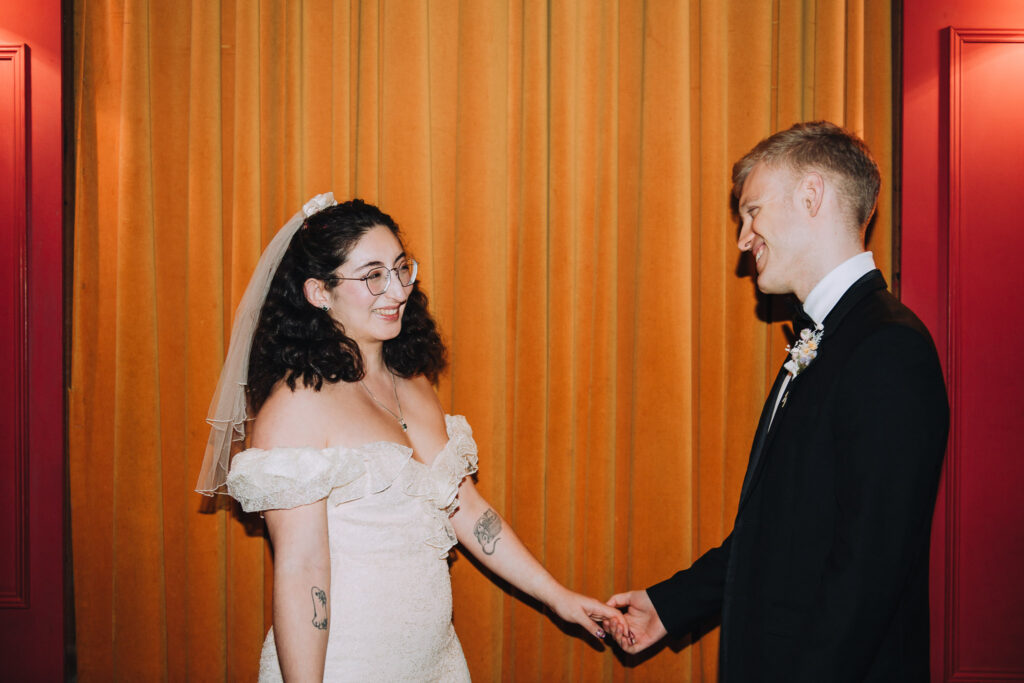 Bride and groom standing together in the Palace Cinema in Broadstairs
