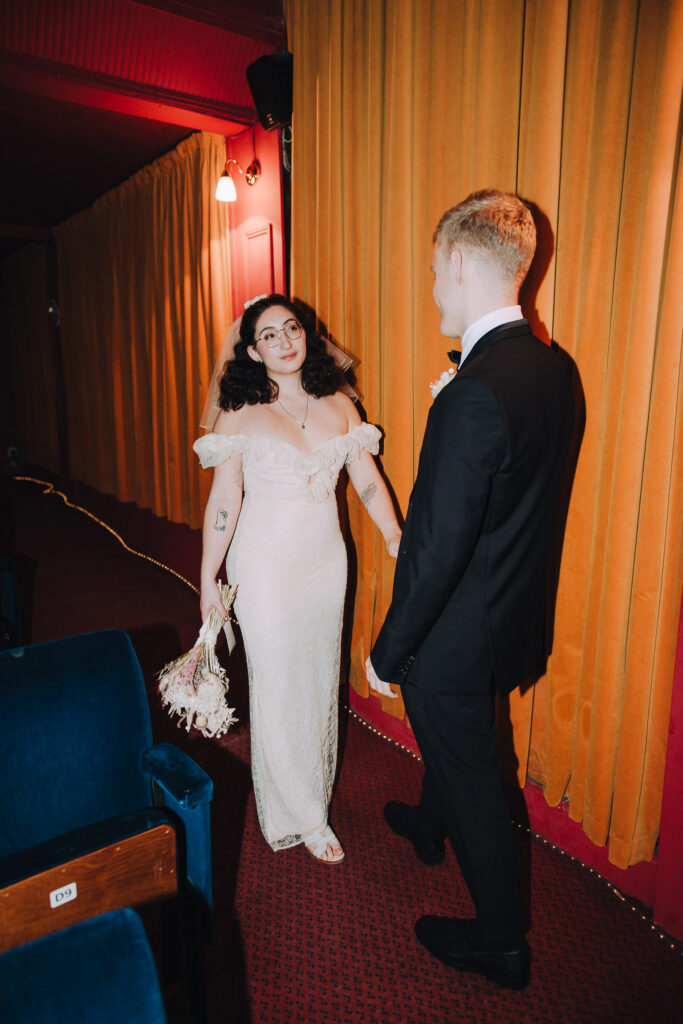 Bride and groom standing together in the Palace Cinema in Broadstairs