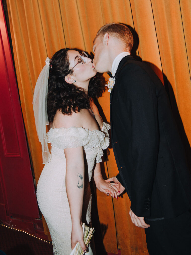 Bride and groom kissing in the Palace Cinema in Broadstairs