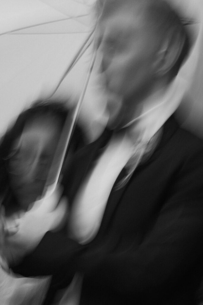 Bride and groom running through rain in Broadstairs