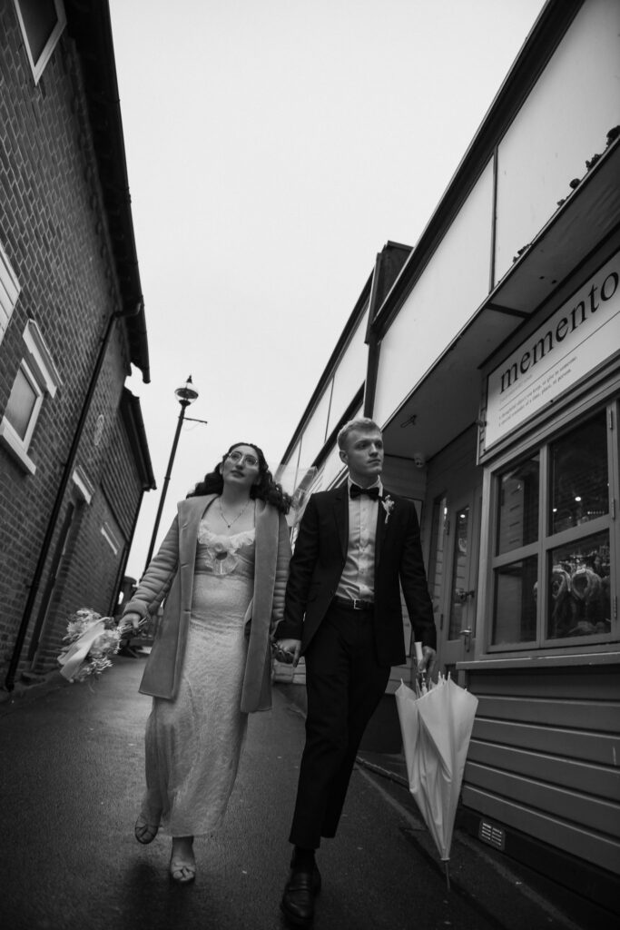 Bride and groom walking through street in Broadstairs