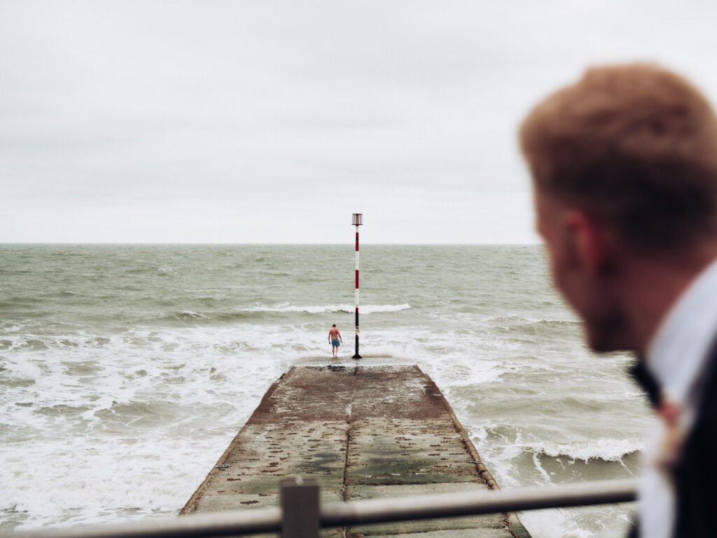 Groom watching wild swimmer