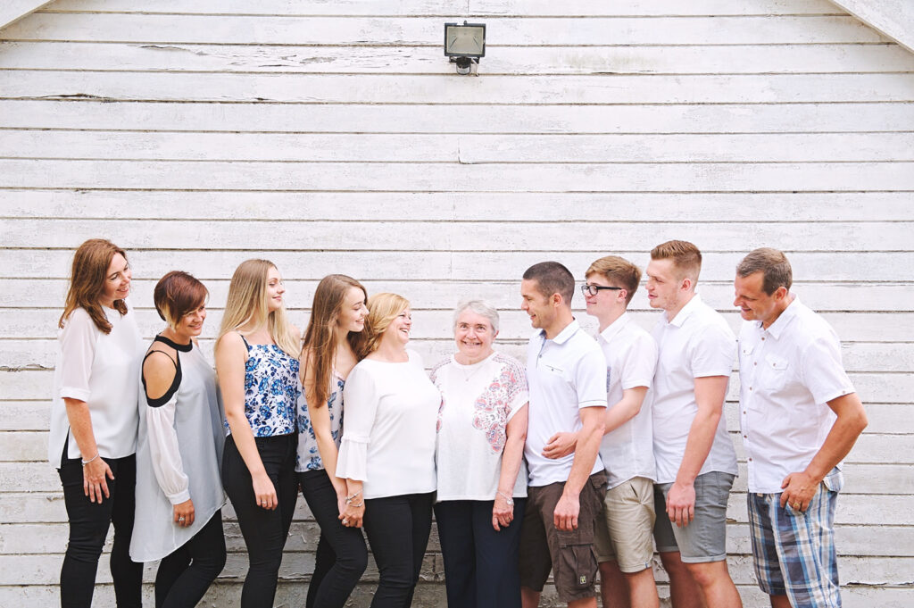 Extended family photography in Kent against a white shed backdrop