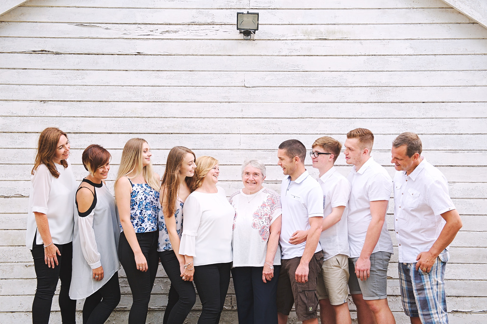 Extended family photo shoot in Kent against a white shed backdrop