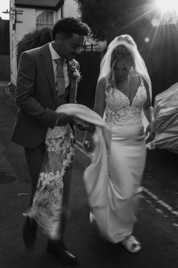 Blurry image of bride and groom walking through Sandwich on their wedding