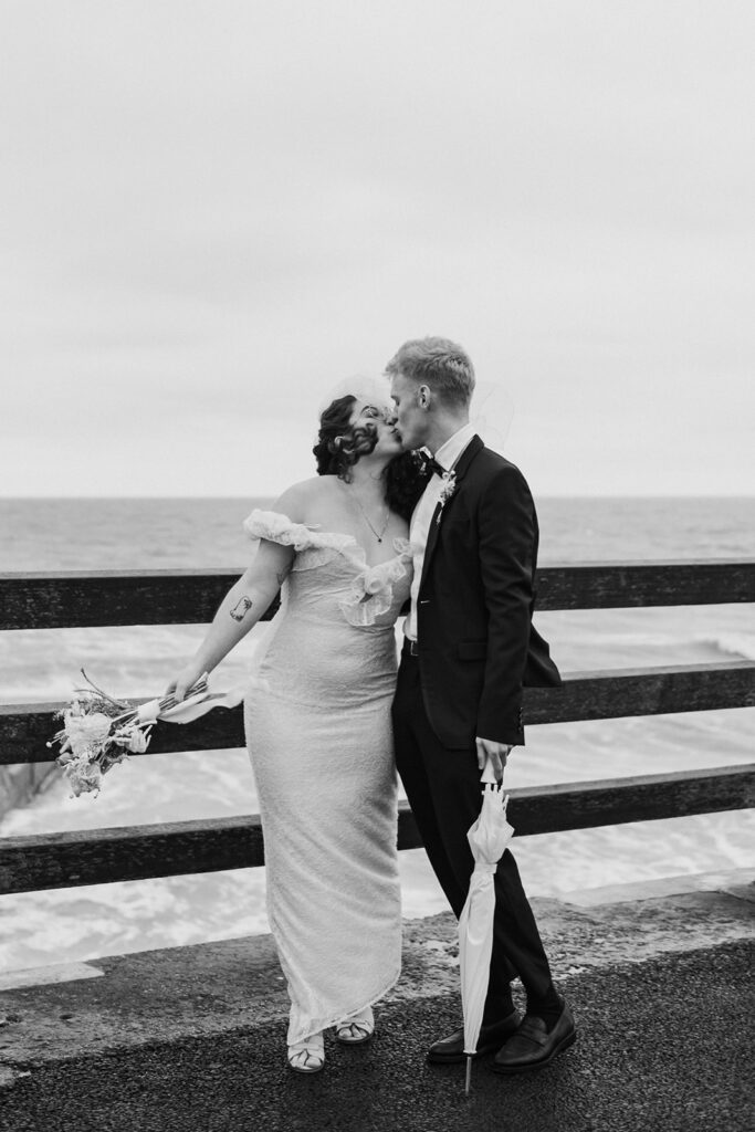 Bride and groom kissing on pier in Broadstairs