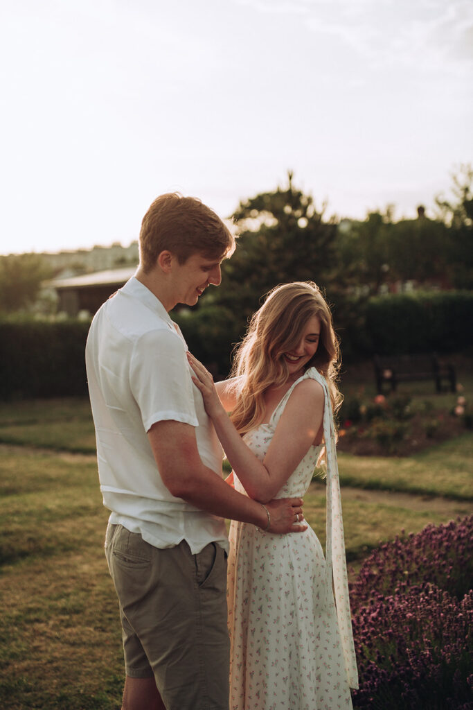 Bride and groom cuddling in West Cliff Rose Gardens one of the best engagement shoot locations in Thanet