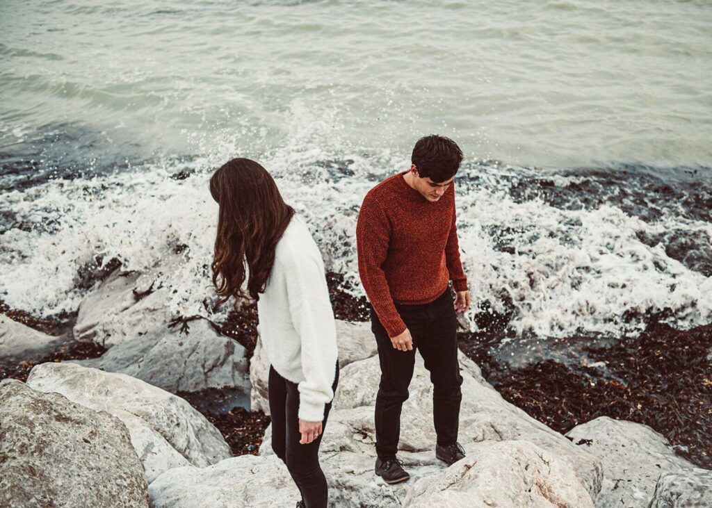 Couple exploring the beaches of Kingsdown in Kent after thinking why have an engagement shoot