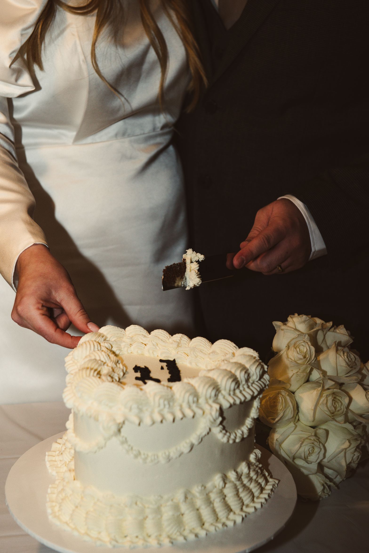 Bride and groom cutting a cake at The Secret Garden in Kent