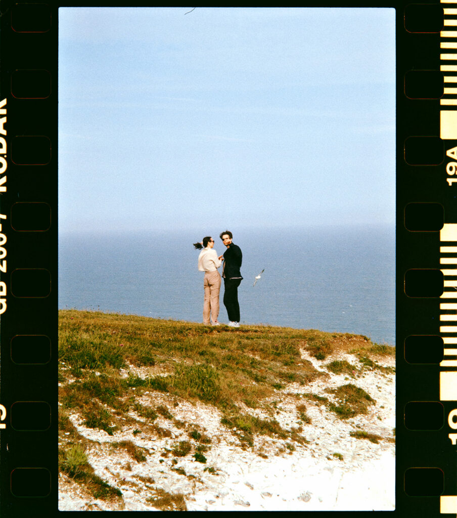 35mm analogue film scan of newly engaged couple on cliffs