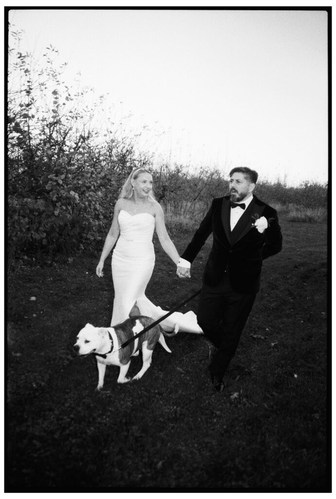 Analogue film scan walking a dog bride and groom at wedding