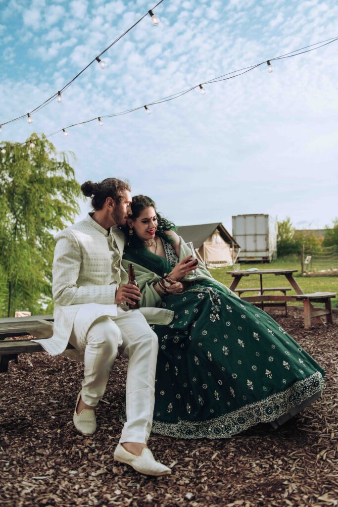 Bride and groom cuddling on bench