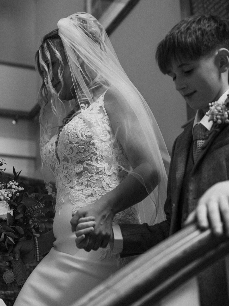 Mother walking down stairs with son