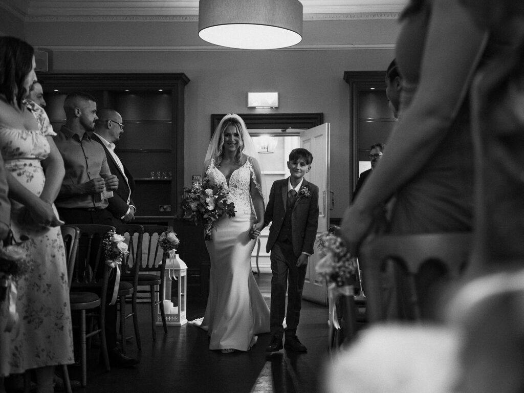 Bride and son walking into ceremony