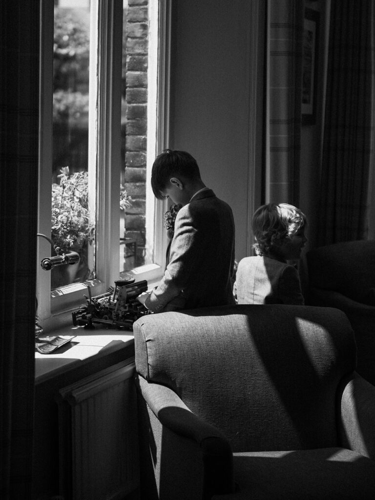 boys playing with typewriter