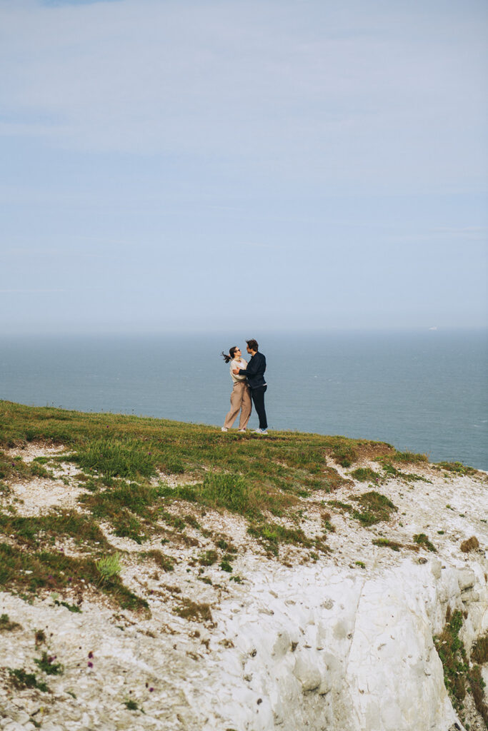 Couple dancing on the cliffs in Dover having just got engaged