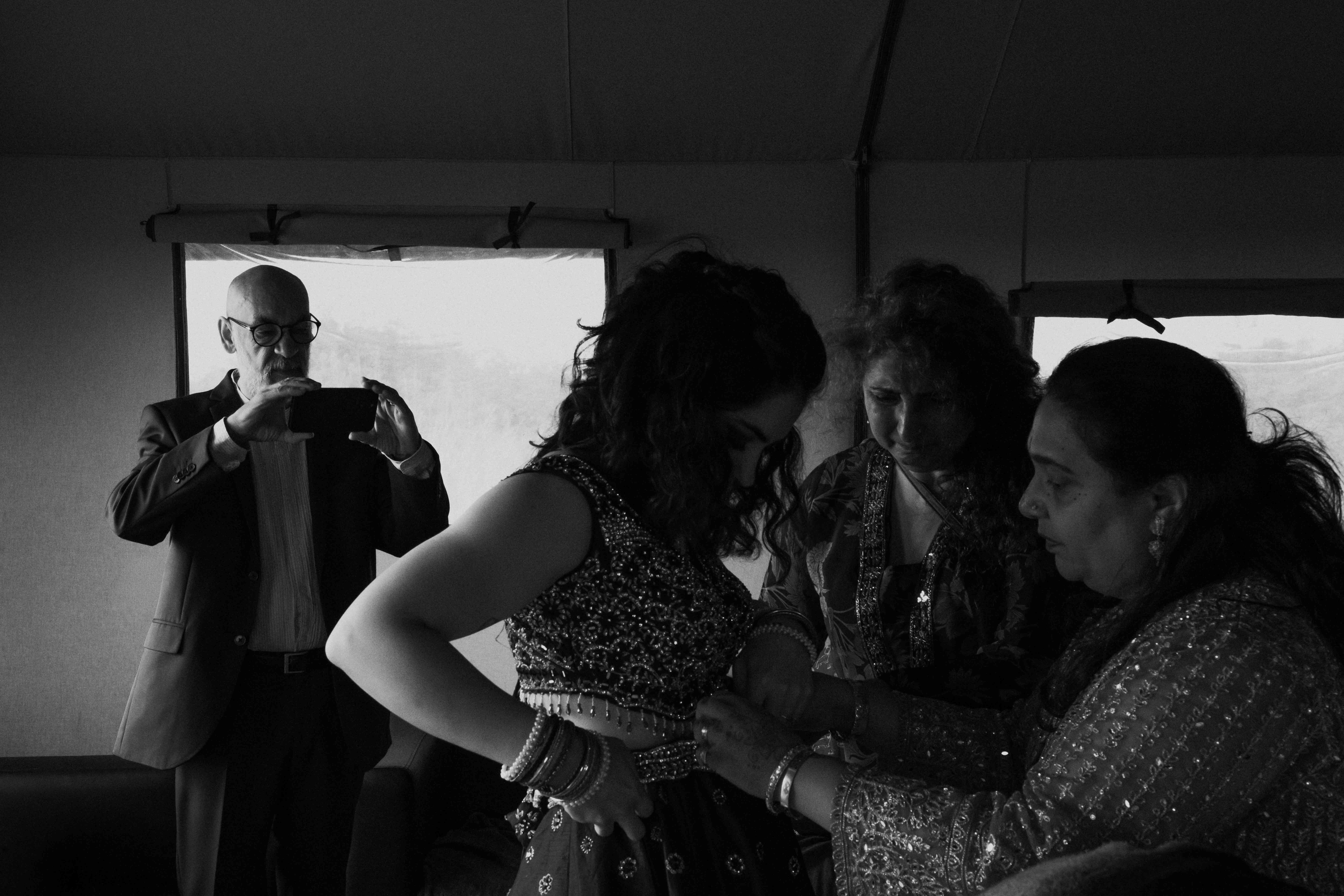 Father of the bride taking photos of bride