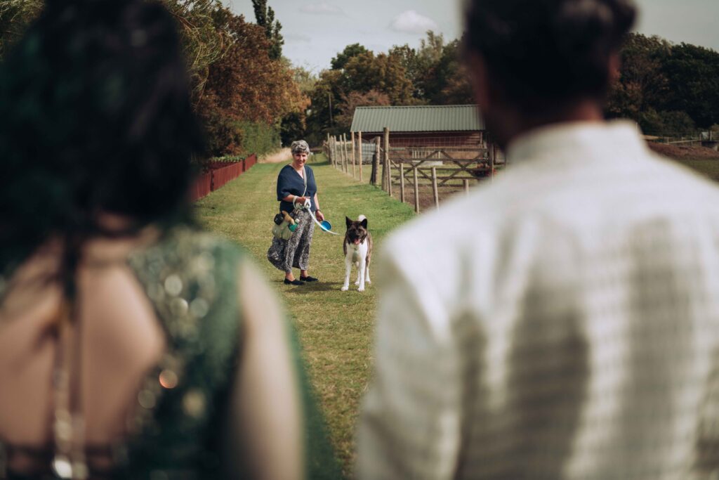 Bride and groom walking to see their dog