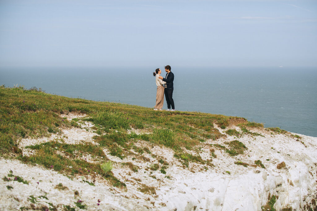 Couple cuddling on Dover cliffs having just got engaged