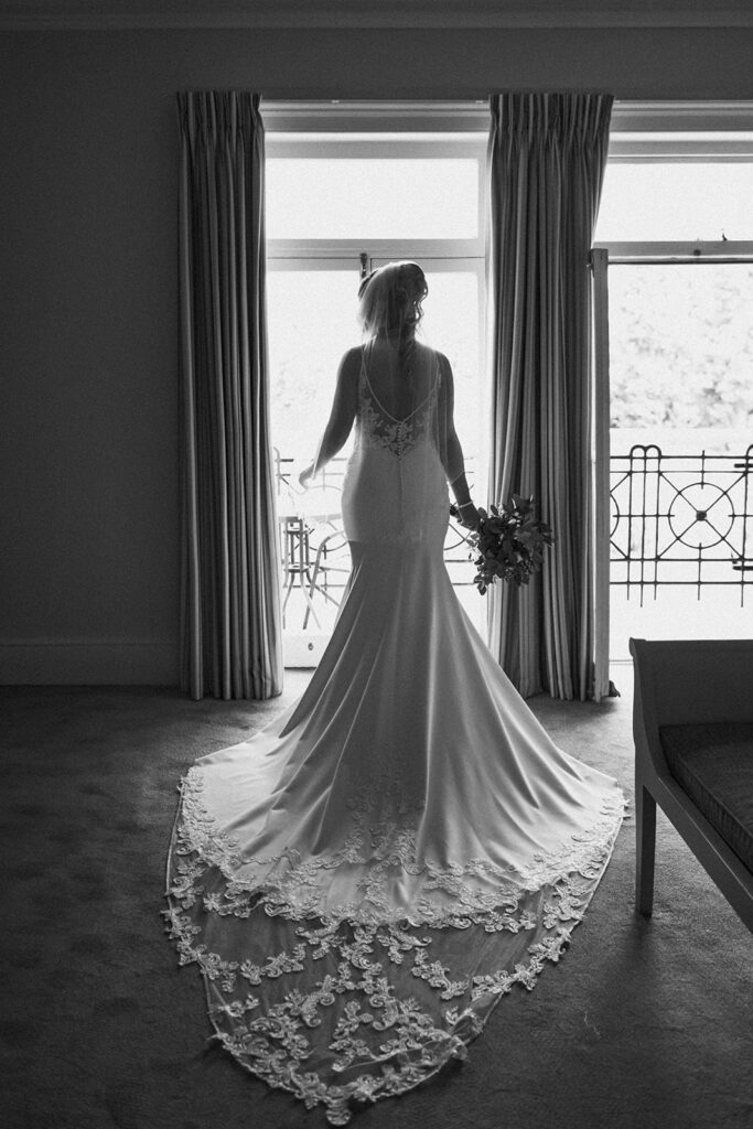 bride stood by balcony window