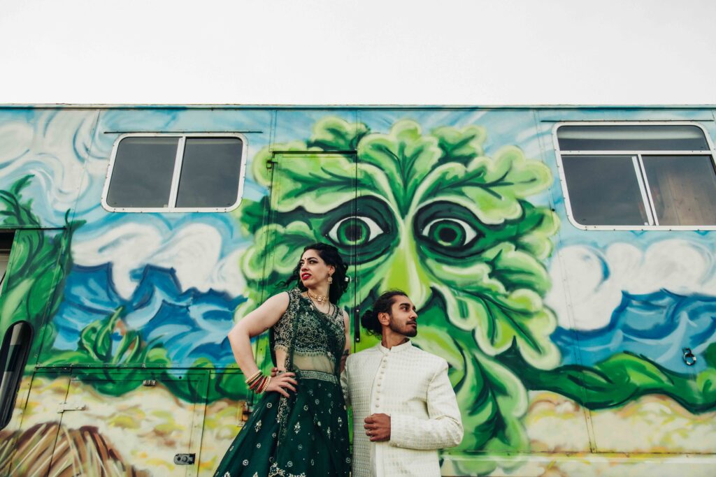 Bride and groom stood in front of caravan