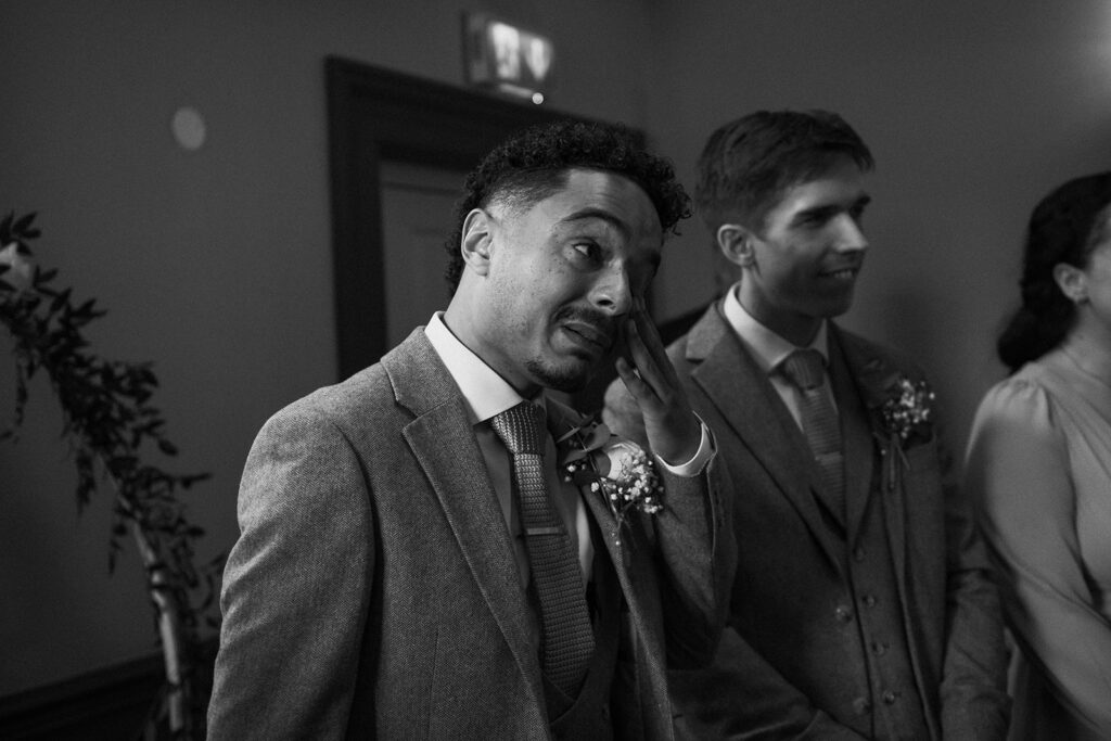 groom wiping tears away