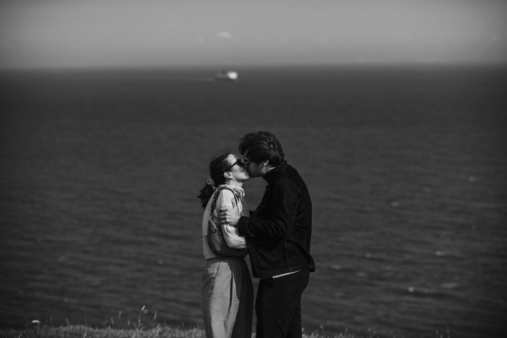 Newly engaged couple in Dover with a ferry in the background