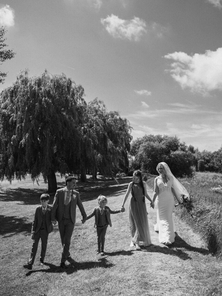Family walking by willow trees in Sandwich