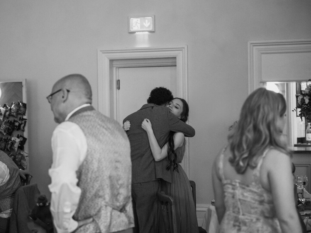 Groom hugging daughter at wedding