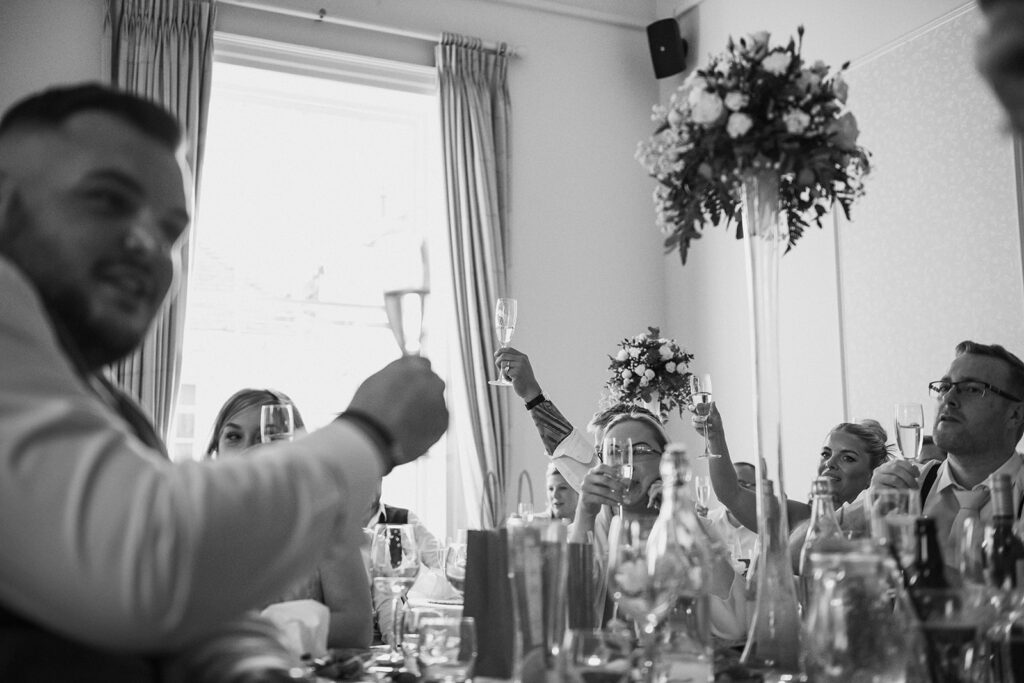 guests raising a toast at wedding