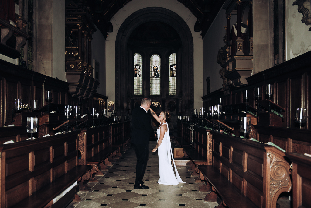 Bride and groom dancing in gonville & caius college