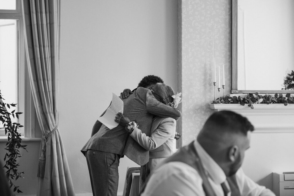 grandmother cuddling grandson at wedding