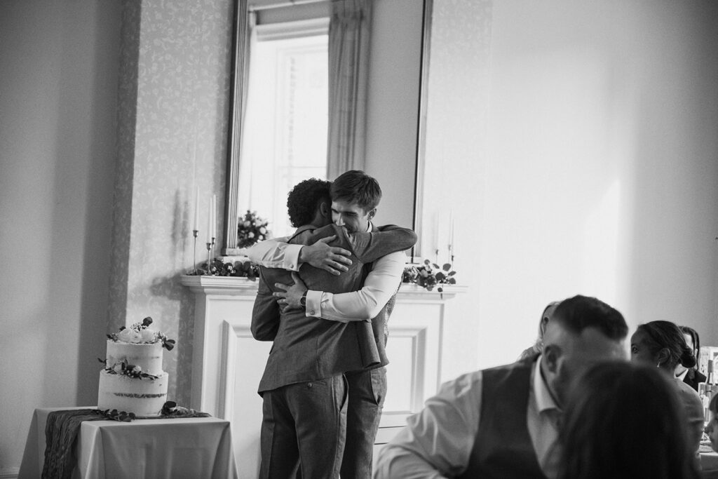 Best man hugging groom